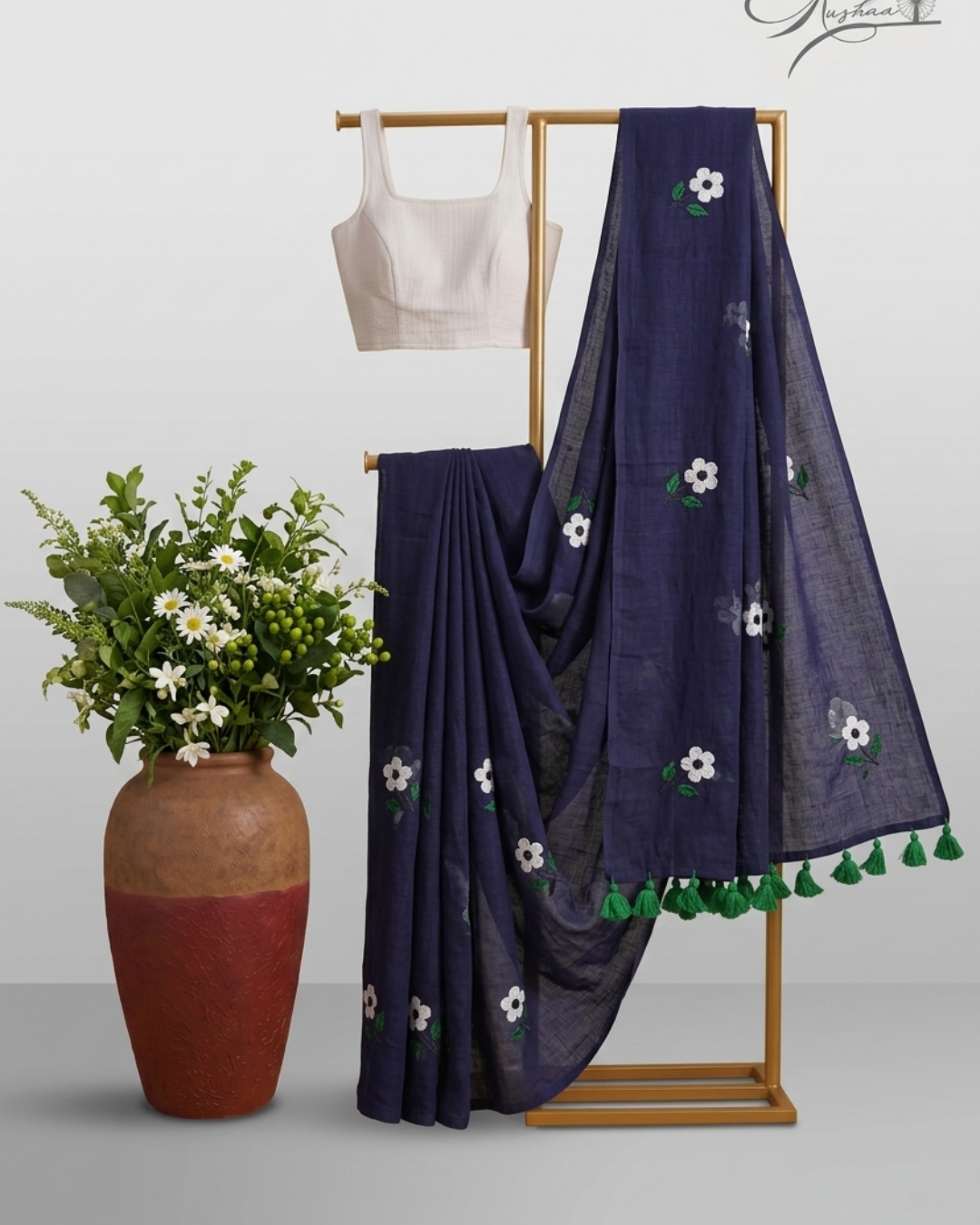 Elegant Navy Blue Mulmul Saree with Floral Embroidery & Green Tassel Border