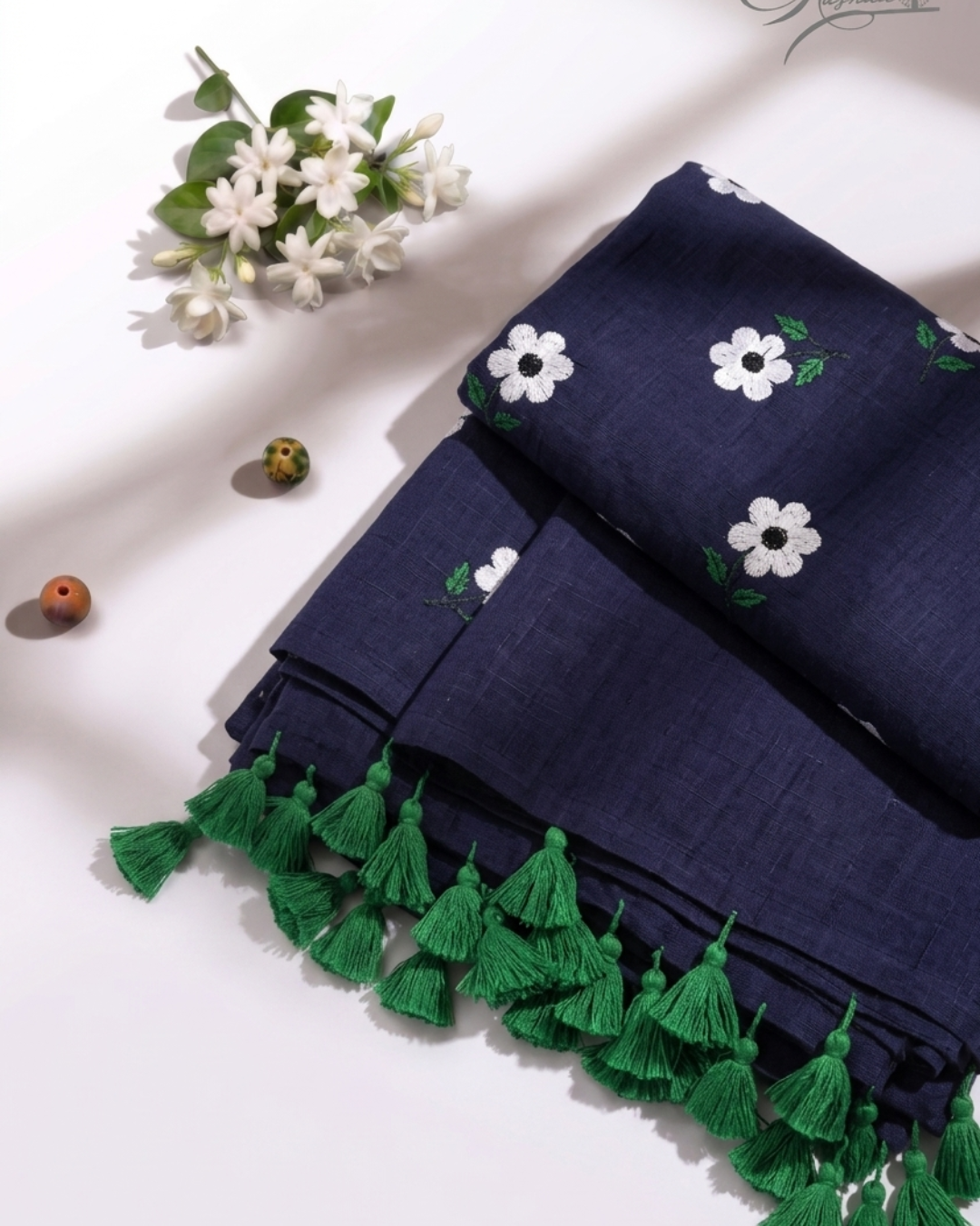 Elegant Navy Blue Mulmul Saree with Floral Embroidery & Green Tassel Border